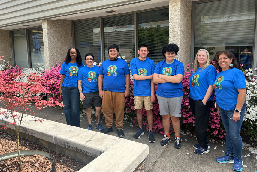 students standing in front of flowers