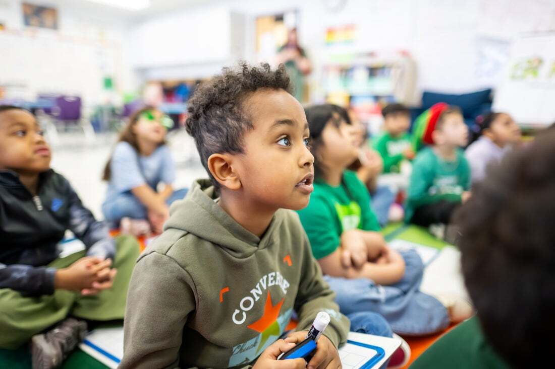First graders engaging in a lesson. 