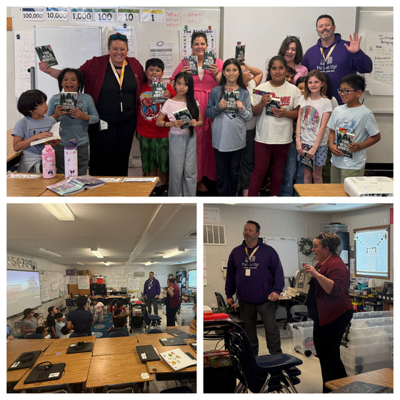 3rd graders holding and receiving their copy of The Wild Robot
