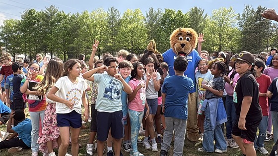 4th Grade students celebrating winning the spirit competition with Mr. Paws