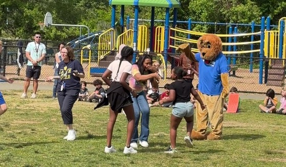 Administrators dancing with students and Mr. Paws in a dance-off at the pep rally