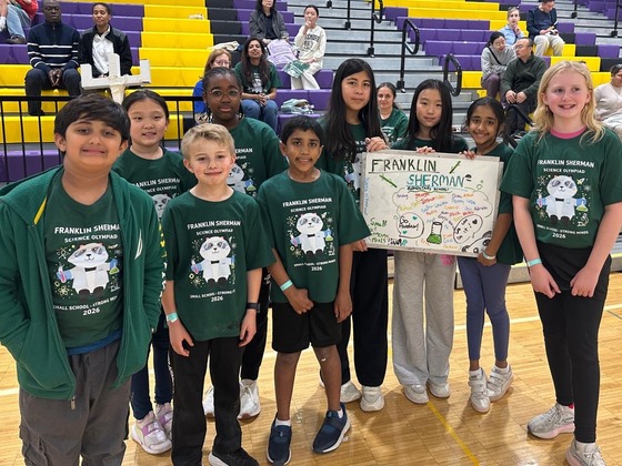 A group of our Pandas posing on the gymnasium floor during the "Science Olympiad" event.