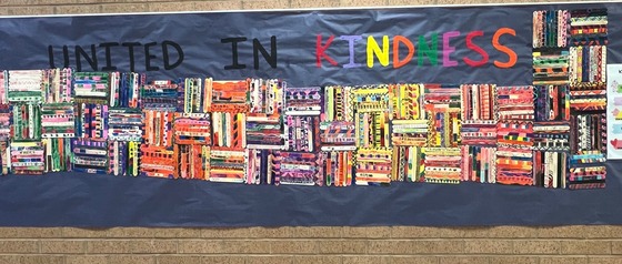 rectangular mosaic-style display made with decorated popsicle sticks with words united in Kindness