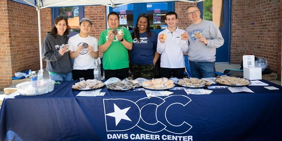 students smiling outside of Davis Career Center