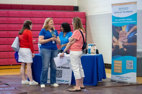 people talking in an exhibitor space