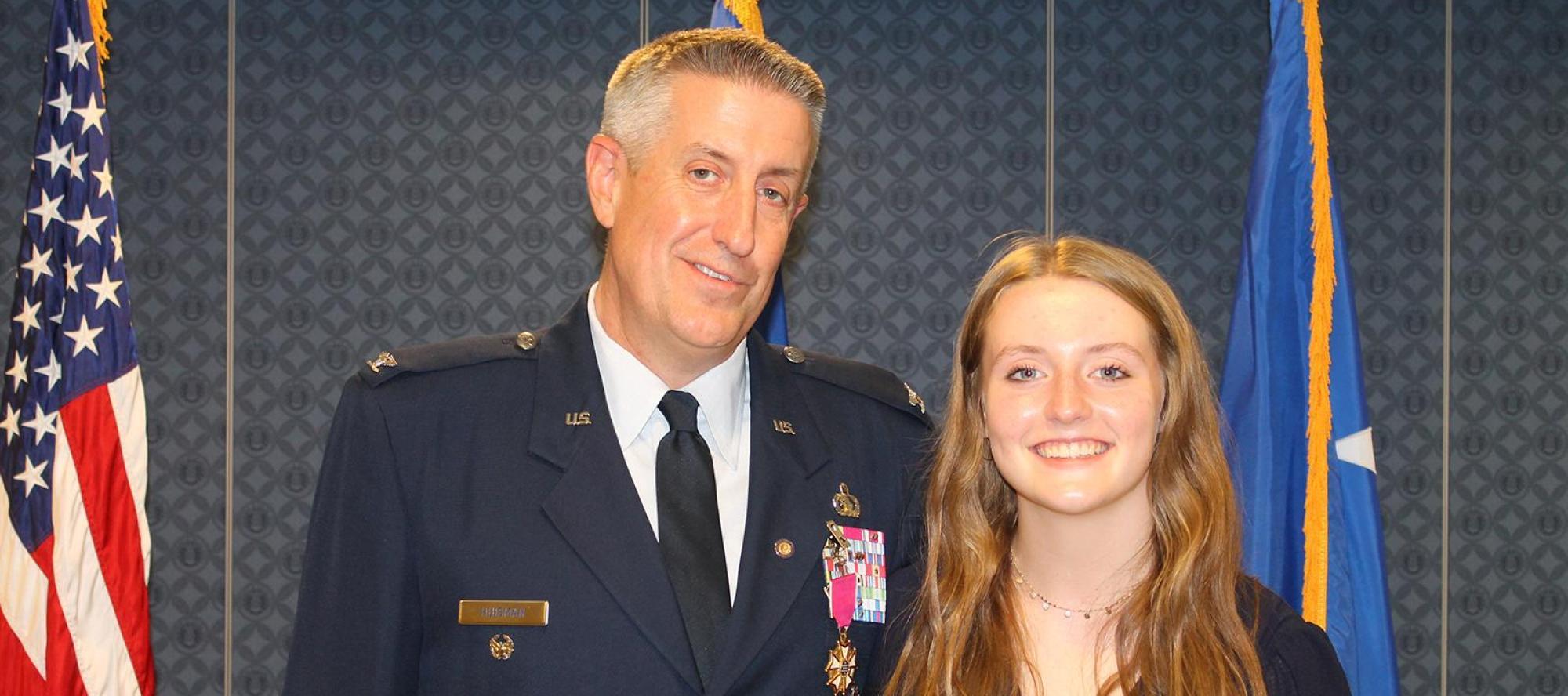 Abby Huisman posing with her Father for Military Child of the year