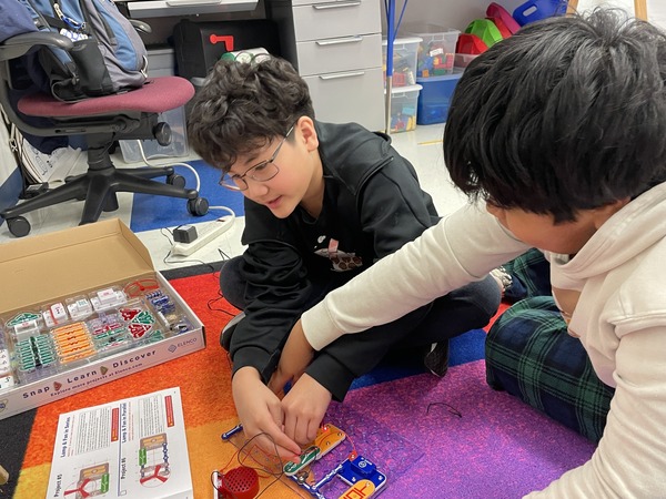 Two sixth graders using snap circuits