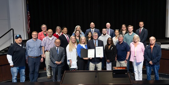 Vaughn Lewis with friends and family posing with the resolution