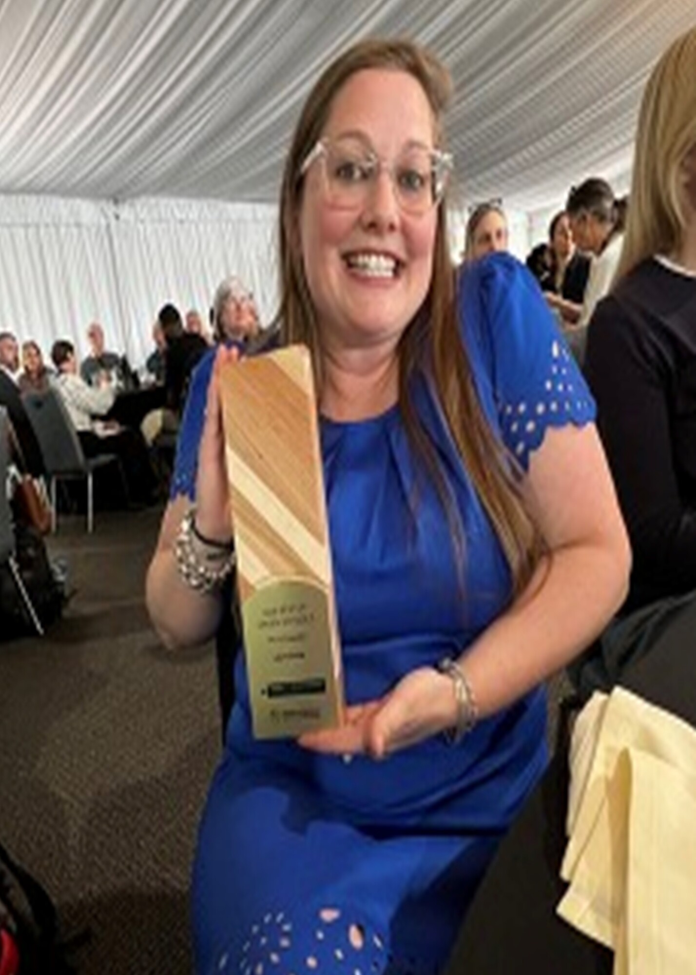 Ms. Grove holding her award