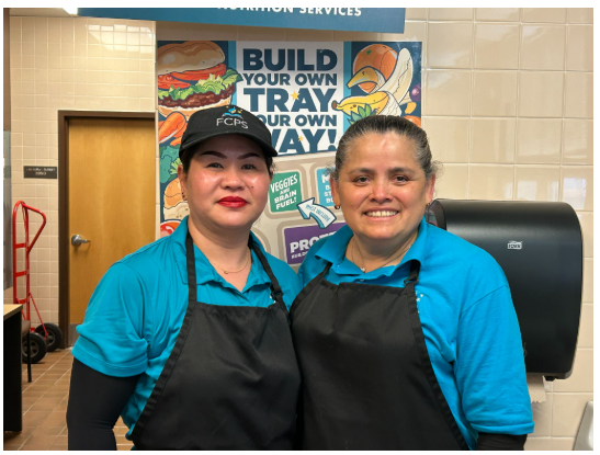 School Lunch Hero- picture of wo lunch ladies in blue tops and black aprons