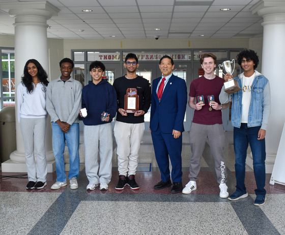 The TJ debate team lined up with all of their team and individual trophies won over the weekend, posing with Mr. Mukai.