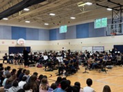 students in the Oakton Band playing instruments in the gym during their concert