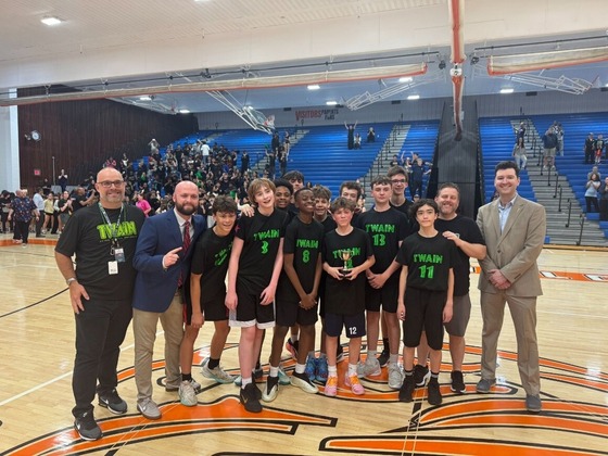a photo of Mr. Mough, Mr. Firebaugh, Mr. Amato, Mr. Murphy, and Twain's Kingstowne Cup winning basketball team