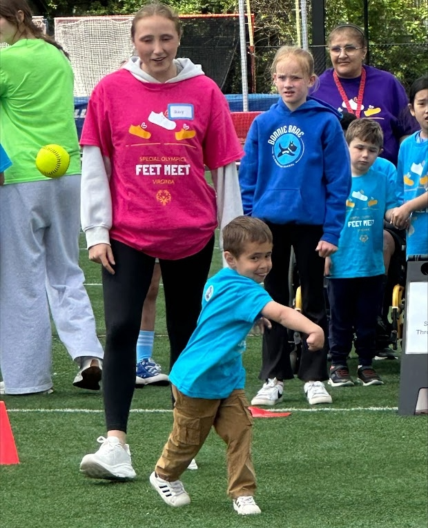 Student throwing a tennis ball.