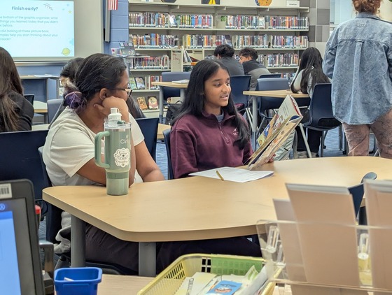 Spanish 2 students working in the library