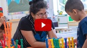 teacher with child and colorful blocks