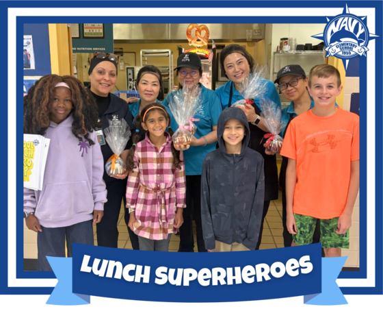 image of our lunch superheroes holding a cake with students smiling