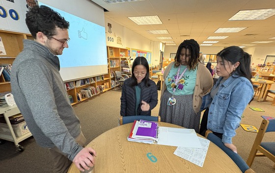 A student showing teachers her organized AVID binder