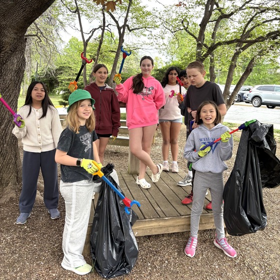 A picture of a group of students picking up trash