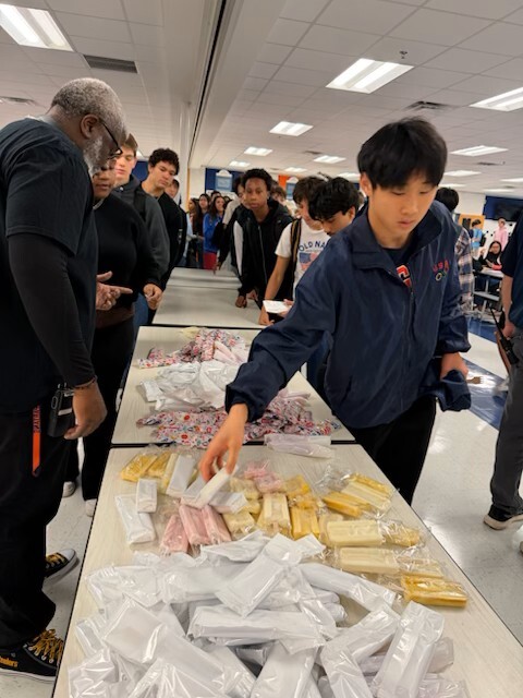 A table of ice cream surrounded by students