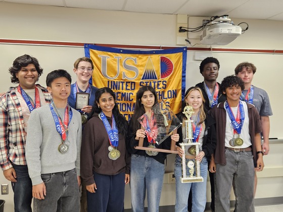 Members of the Academic Decathlon Team back at Thomas Jefferson holding their trophy