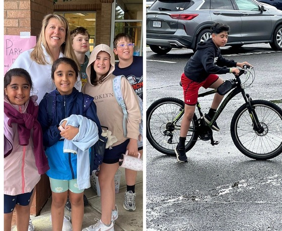 teacher and students gathered for walk to school day with boy on bike