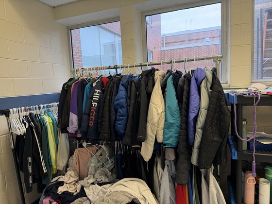 lost and found rack full of coats and clothing items