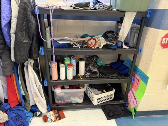 lost and found rack full of bottles and lost items