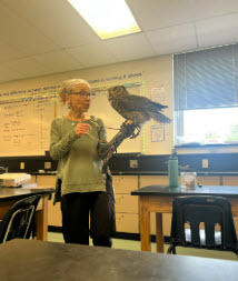 photo of a volunteer showing an owl