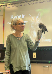 photo of a volunteer showing a small bird