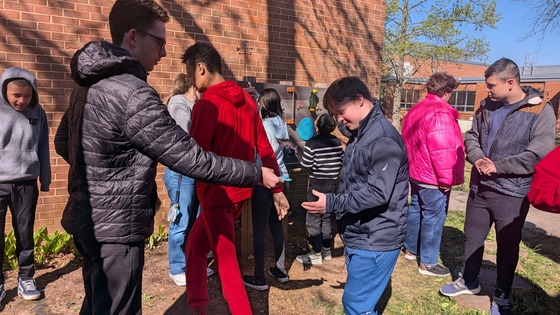 Students enjoying the new courtyard sensory board