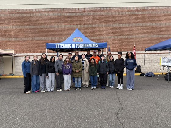 students smiling under a tent