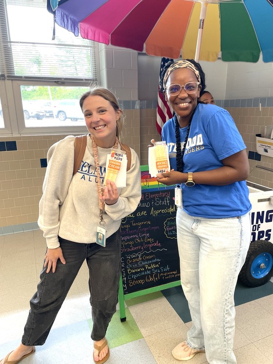 A picture of 2 teachers receiving their ice cream bars