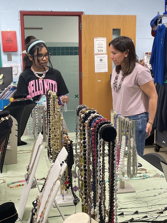 student shopping for jewelry with volunteer