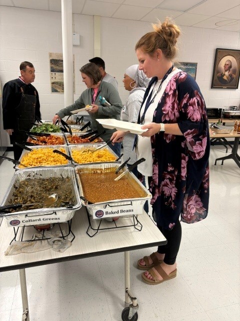 people getting food from a buffet