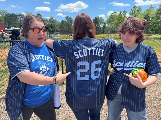 Three teachers showing off their new scotties jersey!