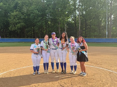 Student athletes standing on a softball field