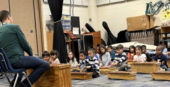 Kindergarten students playing instruments in music class