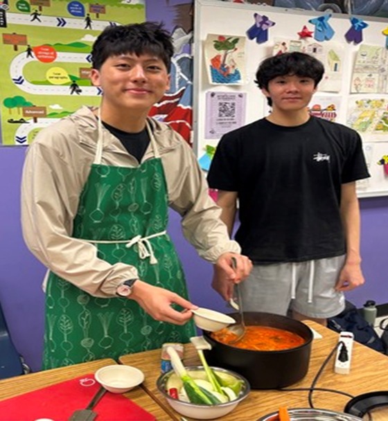 Two students cooking Koran food