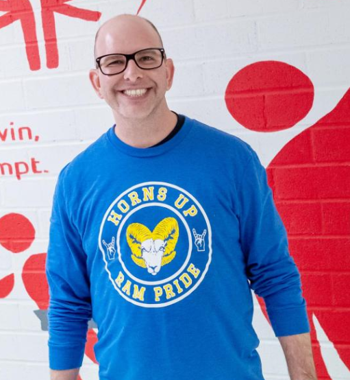 Teacher standing while smiling