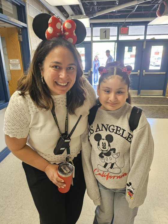 female principal and student wearing mickey mouse ears headbands for Disney day