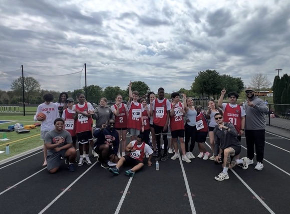 Group of students gathered outside on the track to begin track meet