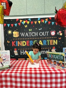Kindergartener Signing Up for Class