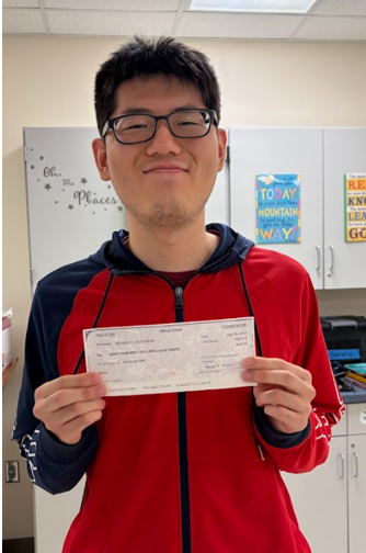 Student holding a check