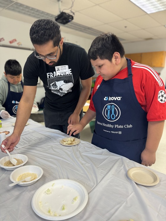 Club leader and a student making cauliflower snacks.