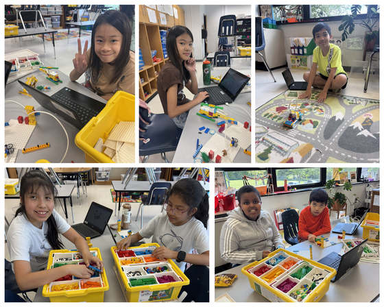 Diverse students in a robotics club using laptops and LEGO Spike kits to build and code motorized models at desks and on a classroom rug.