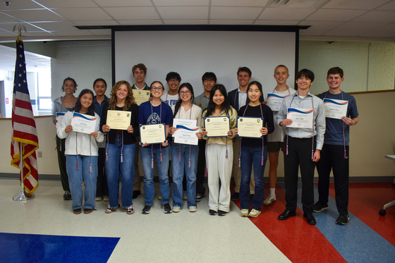 TJ's students entering Military Academies or ROTC programs on scholarship standing in front of a screen.