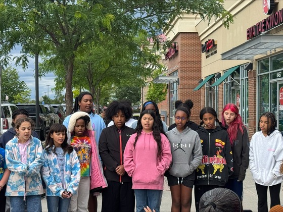 Students singing in front of Bruster's