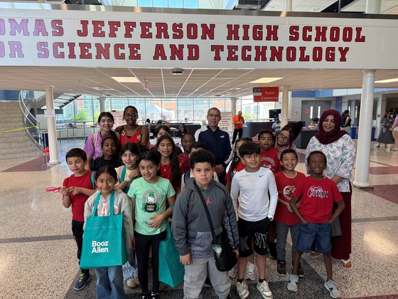 Group of students in front of Thomas Jefferson High School School for Science and Technology sign.
