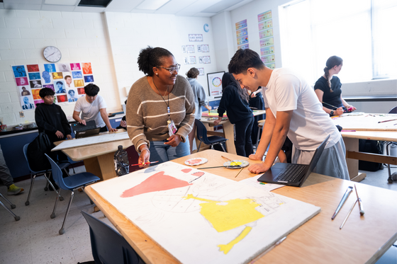 Ms. Little working with a student on an art project